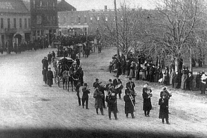 A funeral procession in Goderich, Ontario on Nov. 27, 1913-Horse drawn hearses led by a band, carrying the coffins of five unknown sailors.