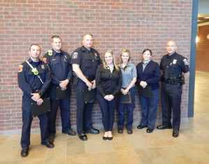 Among those receiving awards from Northville Township for their heroic efforts in saving the life of a 20-year-old woman last December were, from left, Firefighter Will Caruso, Firefighter Brent Muller, Police Ofc. Christopher Cox, Danielle Teper, Dispatcher Jennifer Allen, Dispatcher Jeanette Schrameck and Police Ofc. Douglas Scoggins.